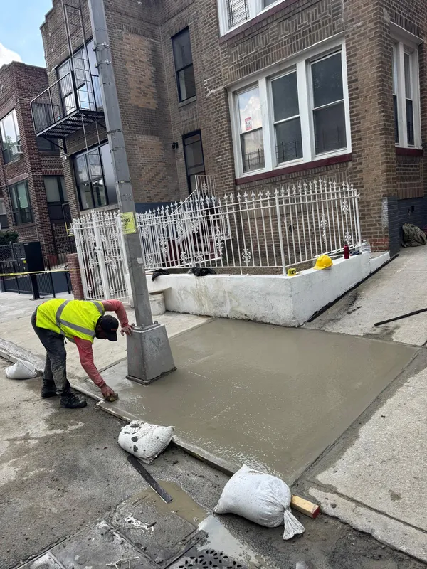 Fresh concrete sidewalk finishing work in Nassau County