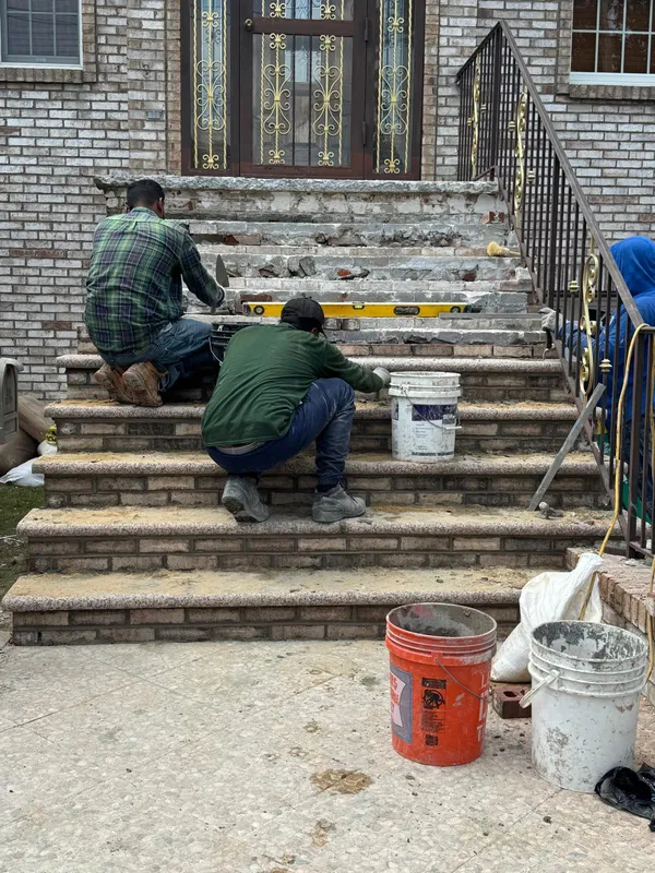 Brownstone front steps restoration project in Queens